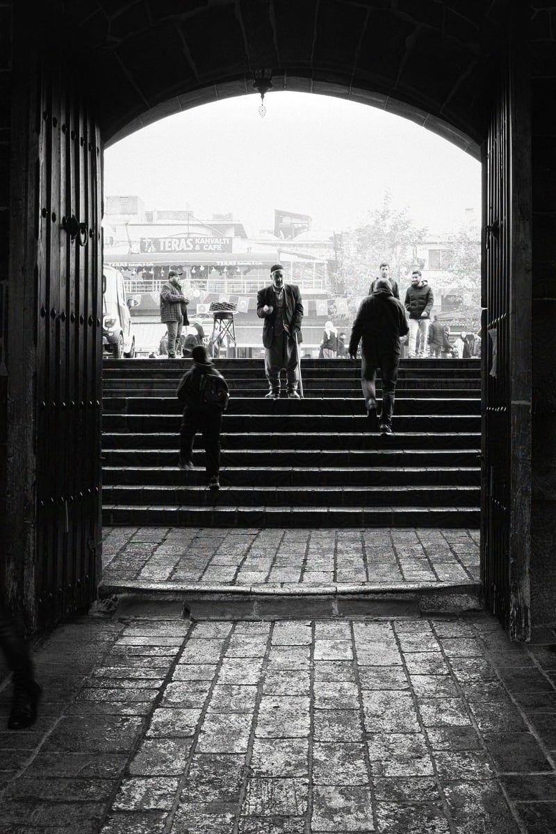 A man praying in front of the mosque main entrance