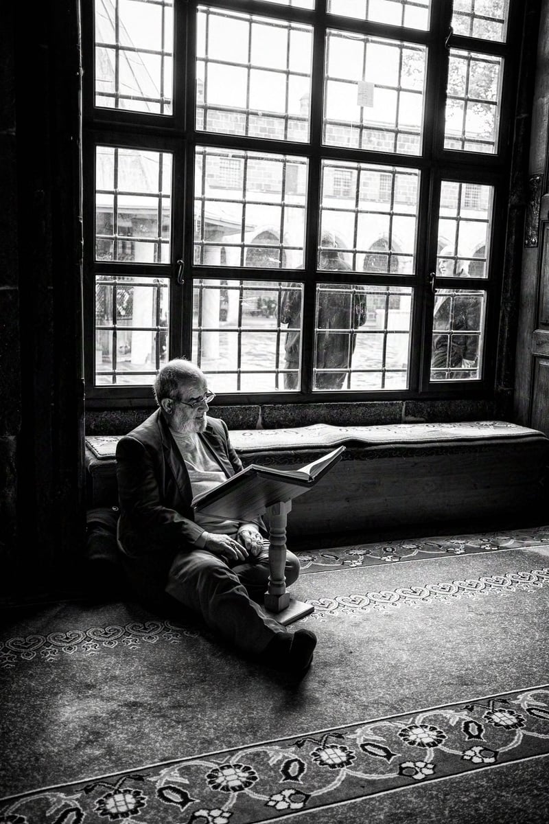 A man reads a book inside the mosque