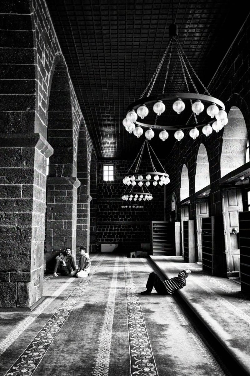 A man relaxing under a chandelier after the prayer