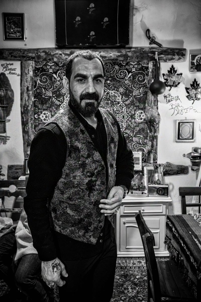 A kurdish man posing inside is delightful shop