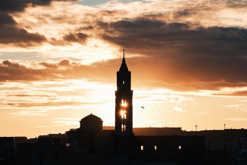The sun setting behind the Cathedral of Matera.