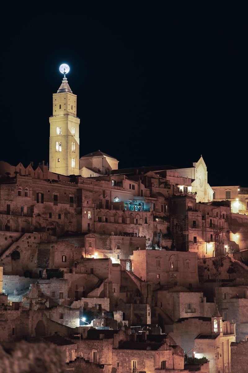 The moon rising behind the bell tower of the Cathedral of Matera.