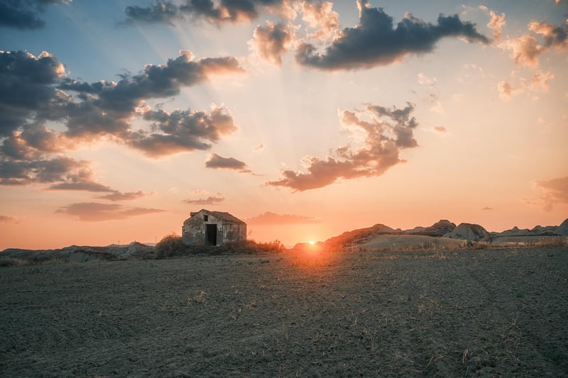 The sun sets behind an abandoned house near Pisticci